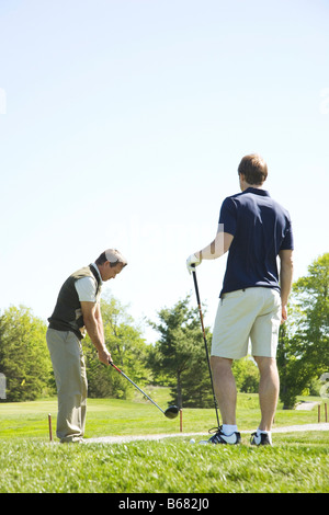 Golfers Practicing on Putting Green Stock Photo