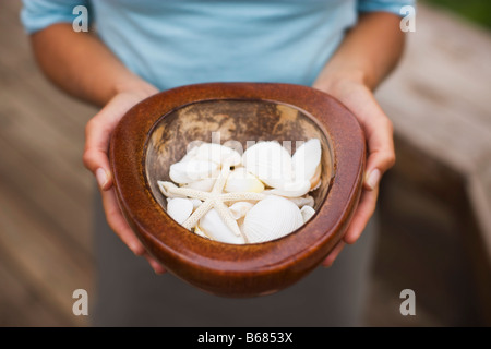 Woman Holding Bowl of Sea Shells, Encinitas, California, USA Stock Photo
