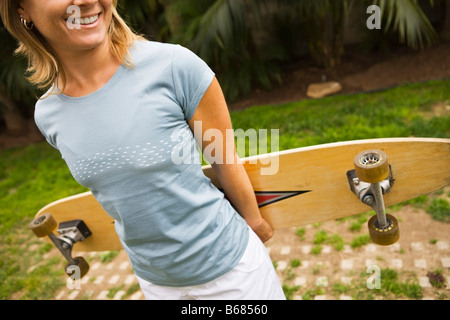 Woman Holding Skateboard Stock Photo