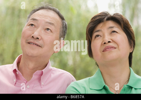 Close-up of a senior man and a mature woman looking up Stock Photo