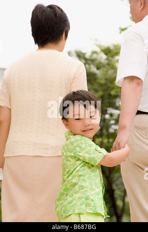 Portrait of a boy walking with his grandparents Stock Photo