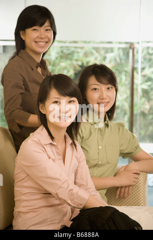 Portrait of three female office workers smiling in an office Stock Photo