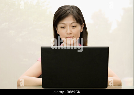 Close-up of a female office worker using a laptop Stock Photo