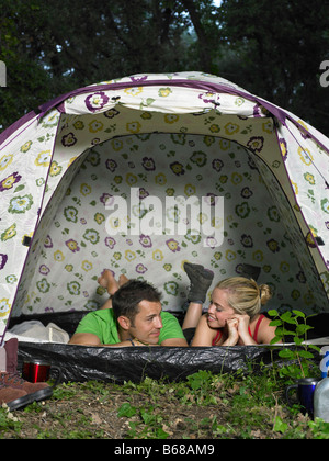 Couple relaxing in tent Stock Photo