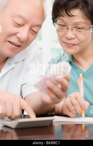 Mature couple using a calculator Stock Photo