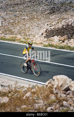 Cyclist on rural road Stock Photo