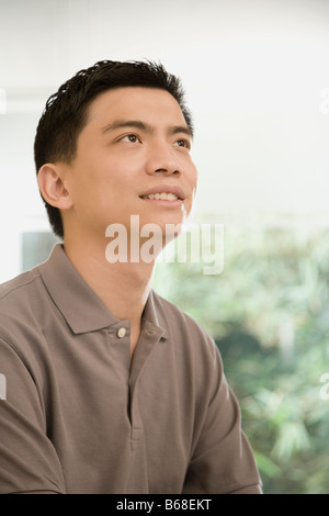 Male office worker looking up and contemplating Stock Photo
