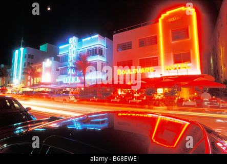 Glowing neon accents art deco era hotels along Ocean Drive at twilight Miami Beach Florida Stock Photo