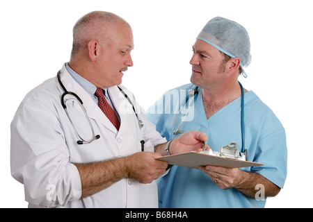 An older doctor instructs an intern as they discuss a patient s medical history Isolated Stock Photo
