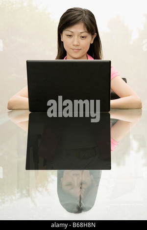 Female office worker using a laptop Stock Photo