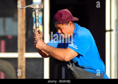 Hard working man swinging a pick Stock Photo