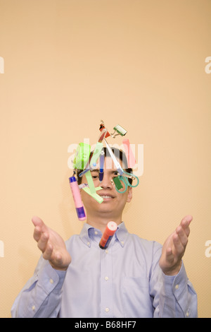 Close-up of a young man tossing stationery objects Stock Photo