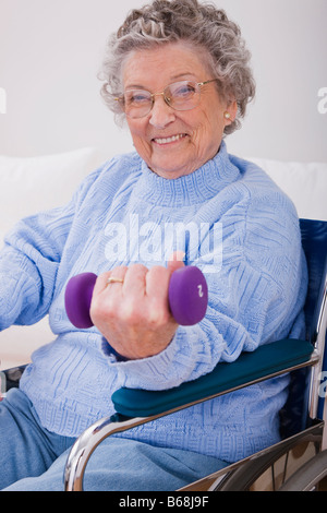 Portrait of senior woman exercising with hand weights Stock Photo