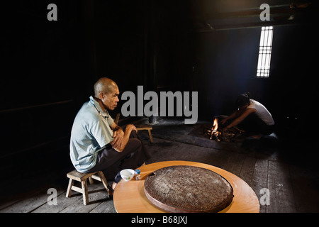 Side profile of a senior man preparing food, Jinkeng Terraced Field, Guangxi Province, China Stock Photo