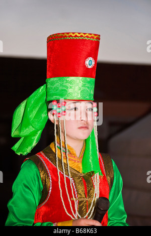 Young woman holding a microphone and singing, Inner Mongolia, China Stock Photo