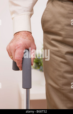 Close-up of senior man's hand on walking cane Stock Photo