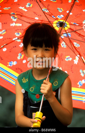 Little girl with umbrella, along Great China Wall China Stock Photo