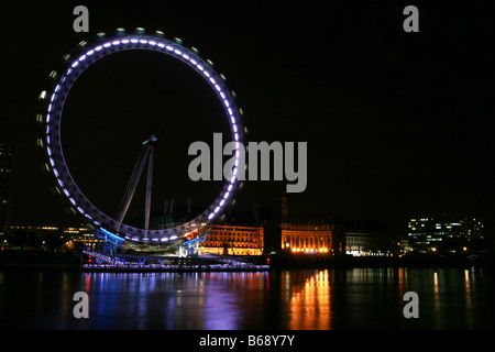 London Eye and London Aquarium at night seen from the north bank of River Thames Stock Photo