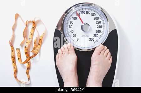 Man's feet on weight scale - Time for gym Stock Photo by ©michaklootwijk  159795848