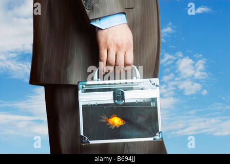 Man carrying transparent case filled with water with goldfish, mid section Stock Photo
