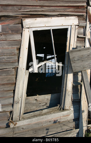 Collapsing empty window frame in a collapsing wooden barn Close up Stock Photo