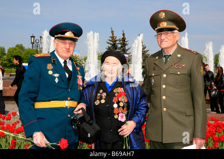 Female Soviet veteran with 2 Colonels celebrating World War II Victory Day at Victory Park in Moscow, Russia Stock Photo