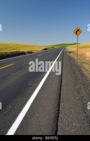 Two lane country road extending to horizon through farmland Eastern ...