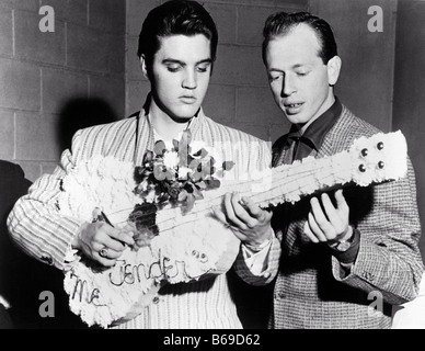 ELVIS PRESLEY promoting Love Me Tender in 1956 with a confectionery guitar Stock Photo