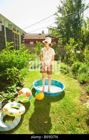 Woman standing in a wading pool Stock Photo