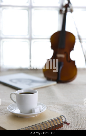 A cup of coffee and a violin on the linen Stock Photo