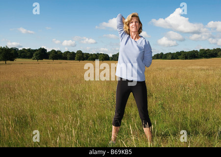 Woman stretching arms behind back Stock Photo