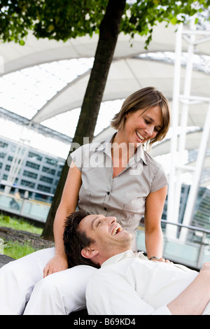 Couple sitting under a tree Stock Photo