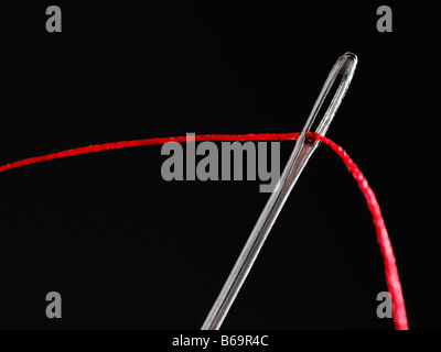 Sewing Needle Close Up With Black Thread through the eye Stock Photo - Alamy