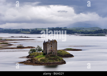 Brooding Storm Clouds Over Castle Stalker at Dusk on Loch Laich Near Appin Scotland Stock Photo