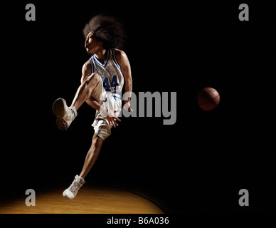 Mixed race basketball player passing basketball