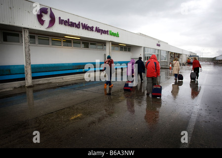 Wet tourists head for the main door at Knock Airport, West Ireland Stock Photo