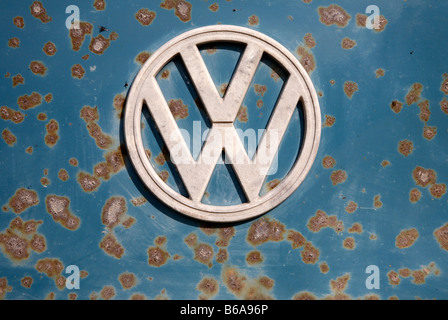 VW badge sign on the front of a rusty old camper van. Stock Photo