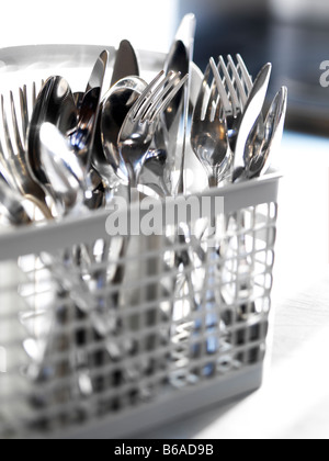 close up selective focus of a full dishwasher utensil basket Stock Photo