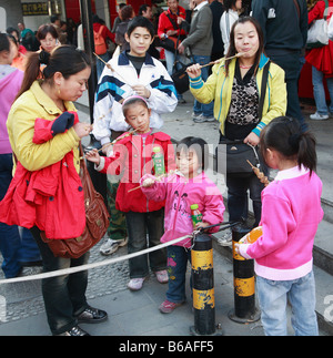 China Beijing Dazhalan traditional shopping street people eating snacks Stock Photo
