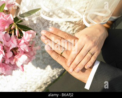 Bride and groom hands with wedding rings Stock Photo