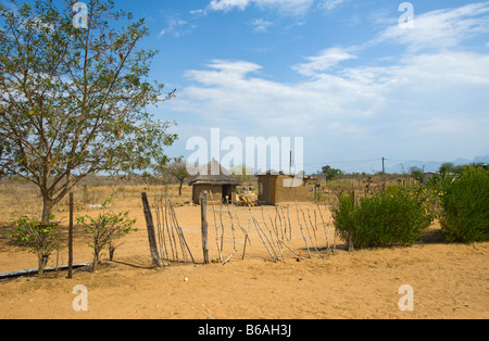 village of BISMARCK Limpopo South Africa hut house home fence bush tree blue sky wide view landscape south africa desert red dus Stock Photo