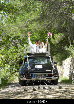 Bride and groom kissing in wedding car Stock Photo