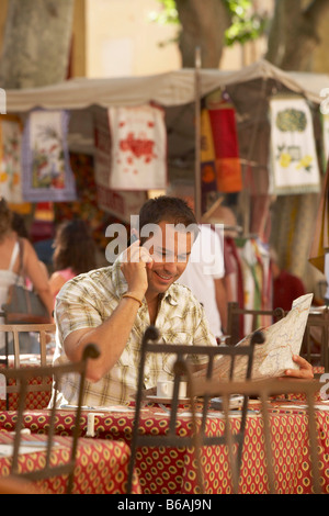 Man talking on phone in french cafe Stock Photo