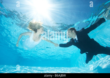 Bride and groom together in pool Stock Photo
