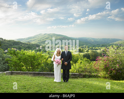Wedding couple in sunlit garden Stock Photo