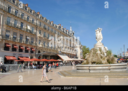 People walking past the fountain on the historic main square 'Place de la Comedie', Montpellier, France, Europe Stock Photo