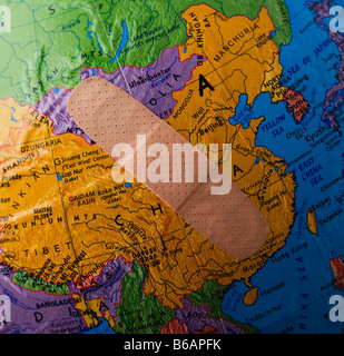 Band-Aid on globe showing China Stock Photo