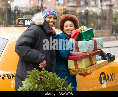 African couple with Christmas presents and wreath Stock Photo