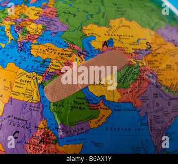 Band-Aid on globe showing Middle East Stock Photo