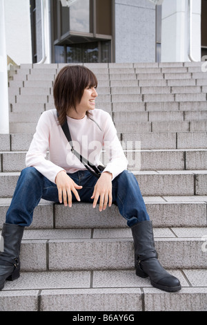 Young man sitting on steps Stock Photo